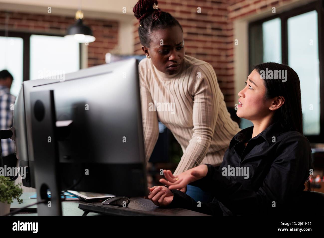 Worried cyber security team members thinking of methods to update defence system without turning it off. Software engineers developing cloud storage network and intelligent algorithm. Stock Photo