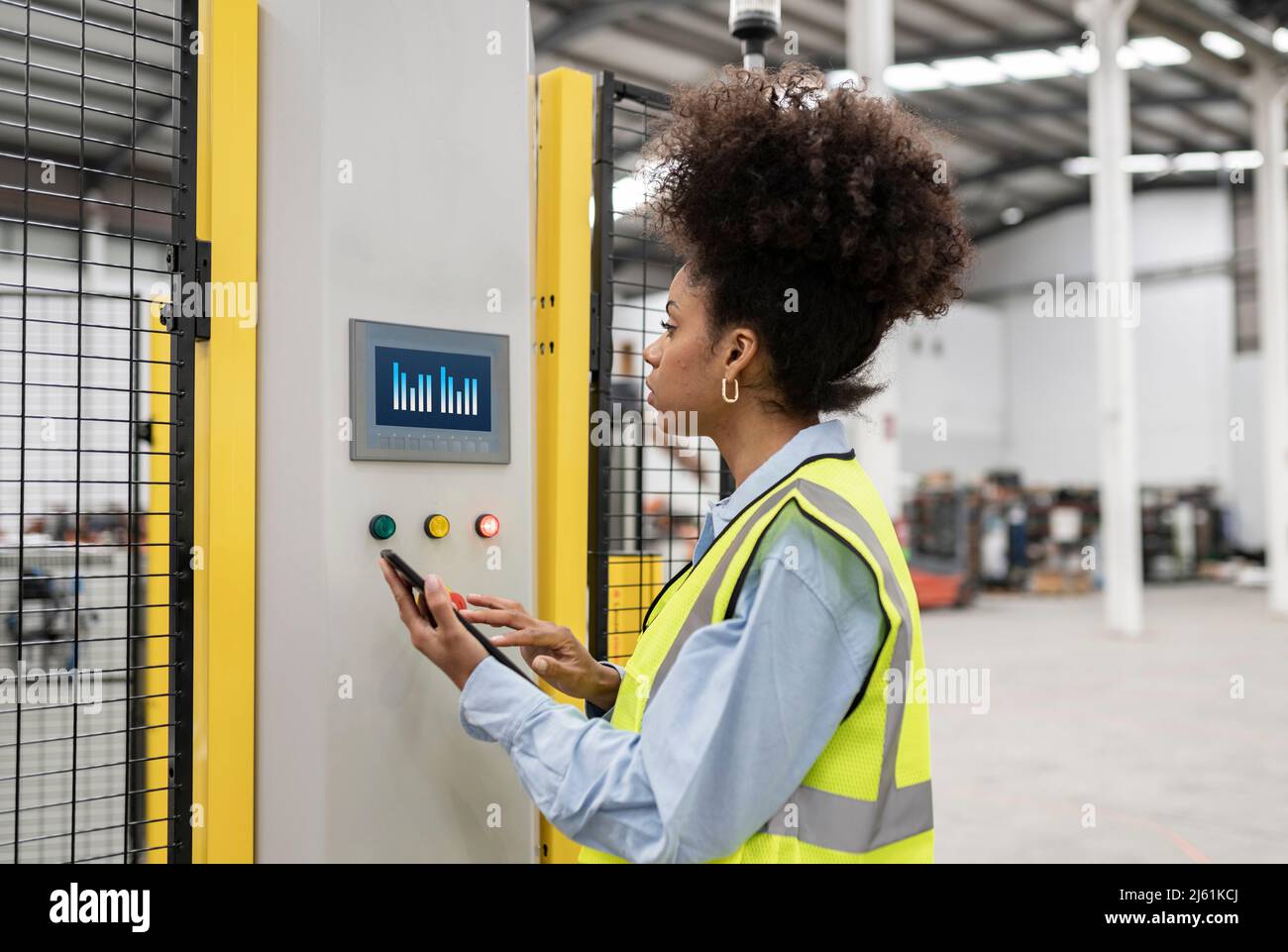 Engineer unlocking security system through tablet PC in factory Stock Photo