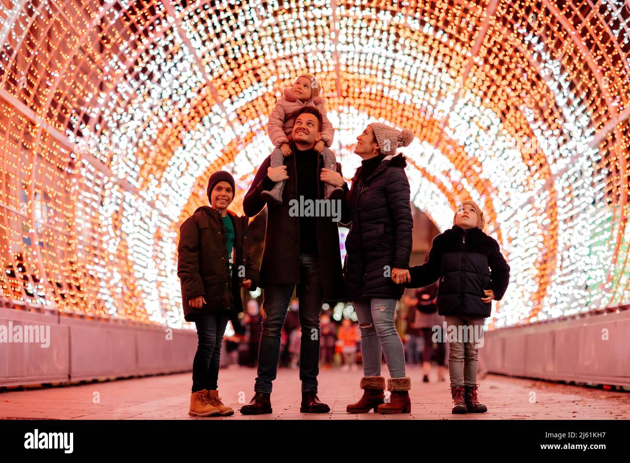 Happy mother and father spending time together with children on Christmas night Stock Photo