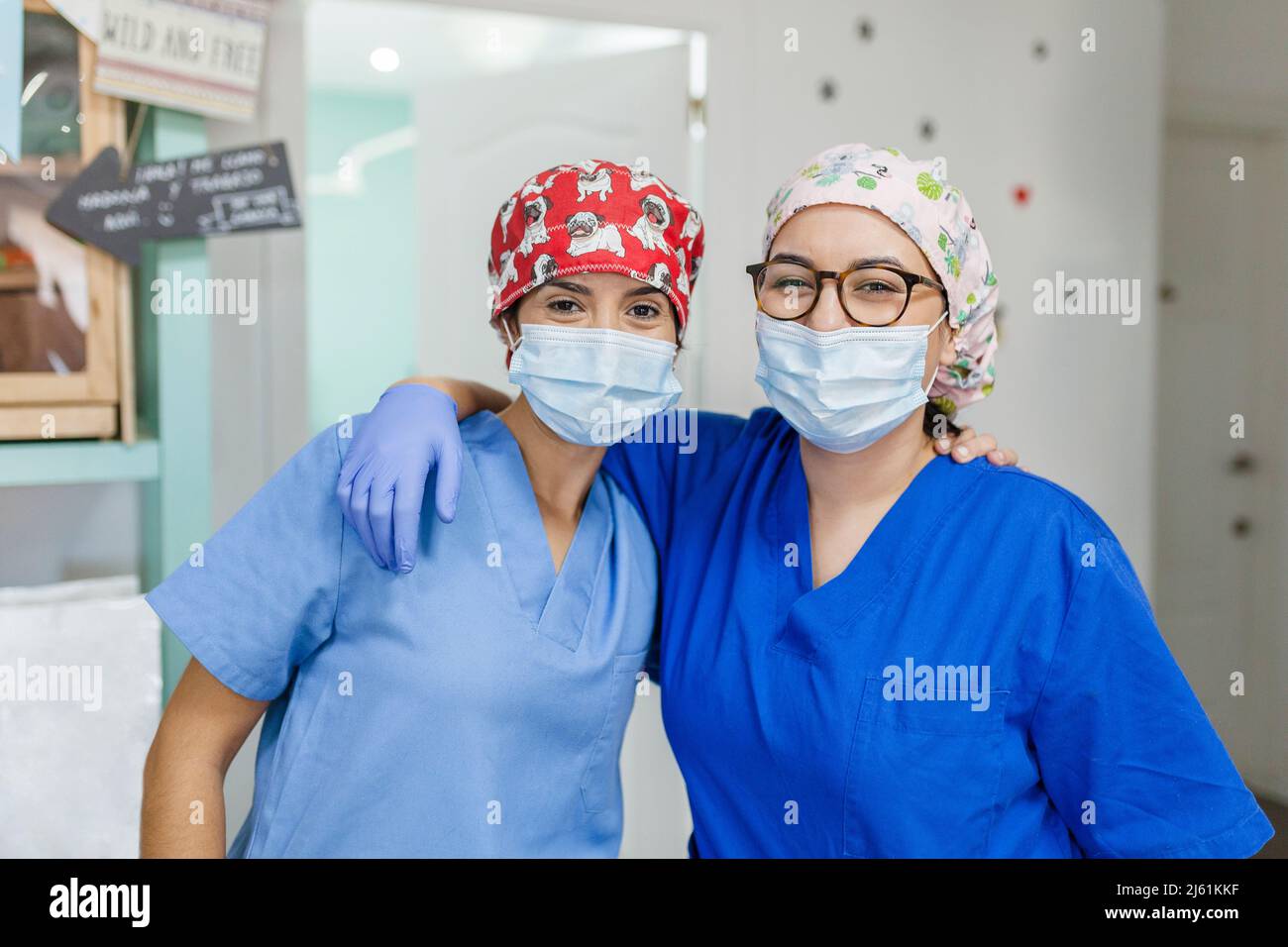 Healthcare worker standing with arm around at veterinary clinic Stock Photo