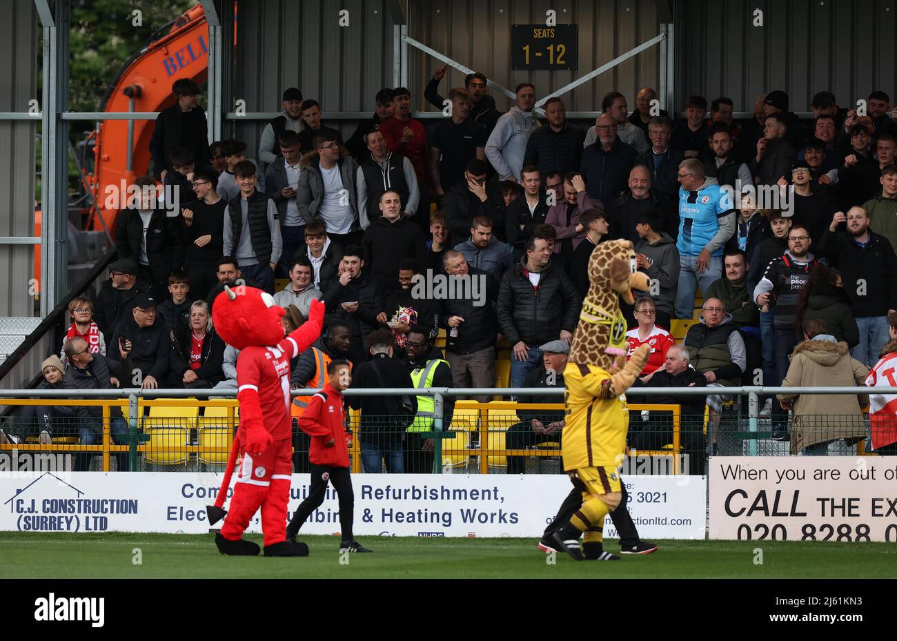 Sutton, UK 26th April 2022 : Sutton United mascot  'Jenny' the giraffe and Crawley Town’s mascot Reggie the Red Devil seen before the EFL League Two match between Sutton United and Crawley Town at tSutton Football Club. Credit: James Boardman/Alamy Live News Stock Photo