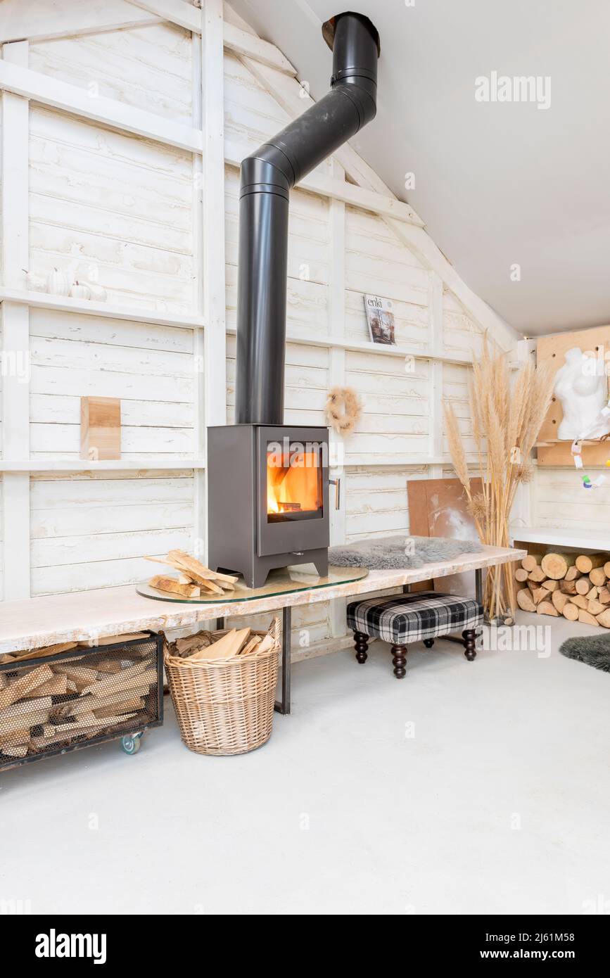 Scandi style log cabin with wood burner Stock Photo