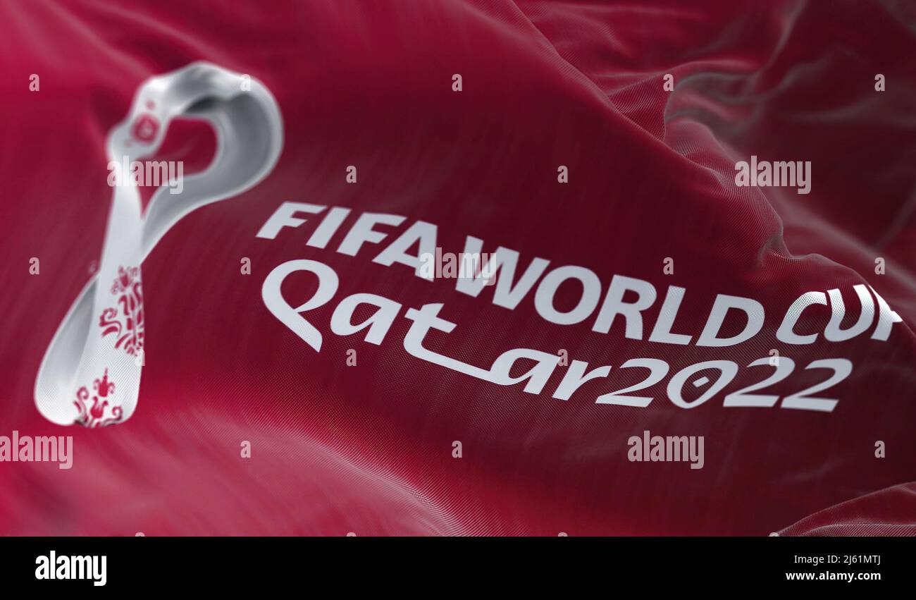 Doha, Qatar, April 2022: A flag with the Qatar 2022 Fifa World Cup logo flapping in the wind. The event is scheduled in Qatar from 21 November to 18 D Stock Photo