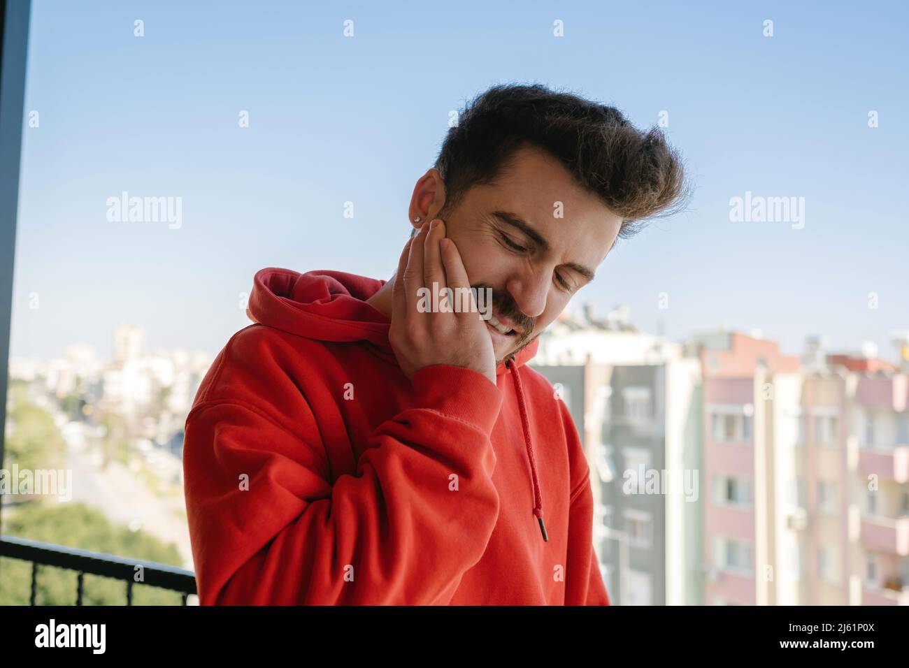 Toothache, young adult suffering a lot in the face of toothache, clenched and gritting his teeth Stock Photo