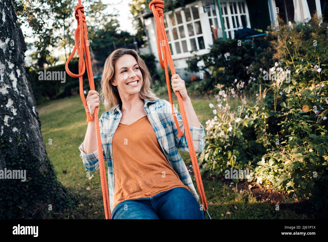 Woman swinging garden hi-res stock photography and images - Alamy