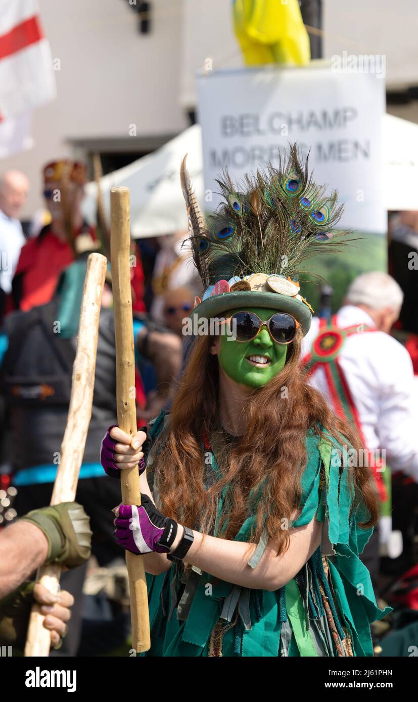 Female Morris dancer UK; A woman Morris dancing a traditional street dance on a sunny day in spring, Hundon village, Suffolk UK Stock Photo