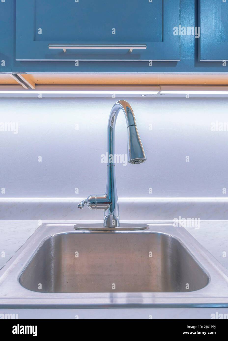 Vertical Stainless sink with single faucet and marble counter Stock ...