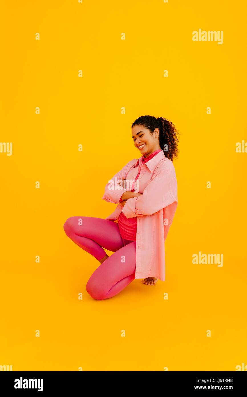 Young woman kneeling arms hi-res stock photography and images - Alamy