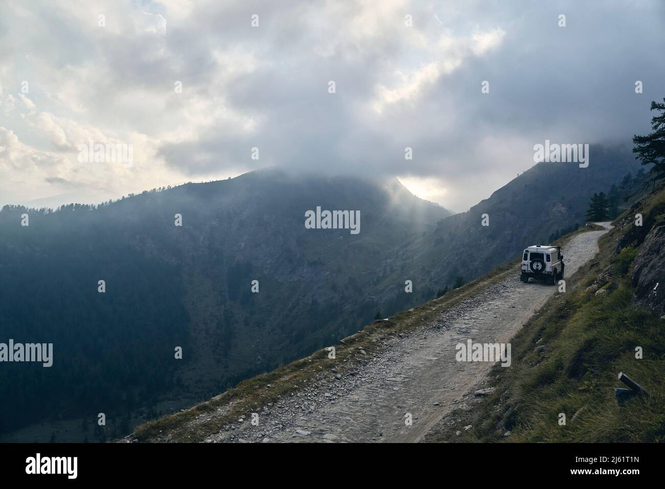Offroad vehicle on road in mountains Stock Photo Alamy