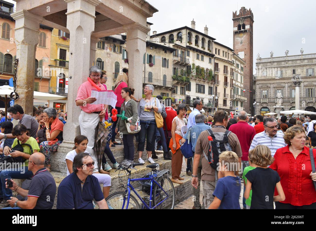 Tourists at Piazza delle Erbe square in Verona Italy. Stock Photo