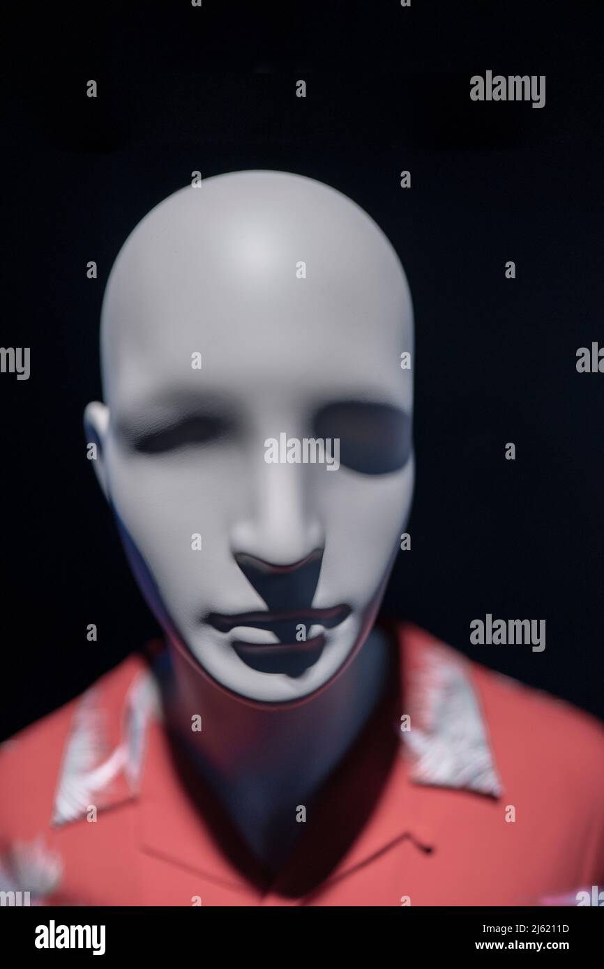Close-up of a mannequin blurred head in a window of a mall on the dark background Stock Photo