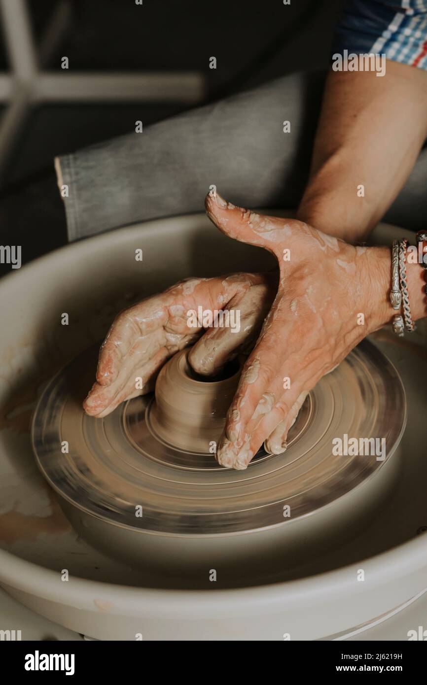 Premium Photo  Potter making a clay object on pottery wheel in outdoors  craftsman moulding clay with hands on potte