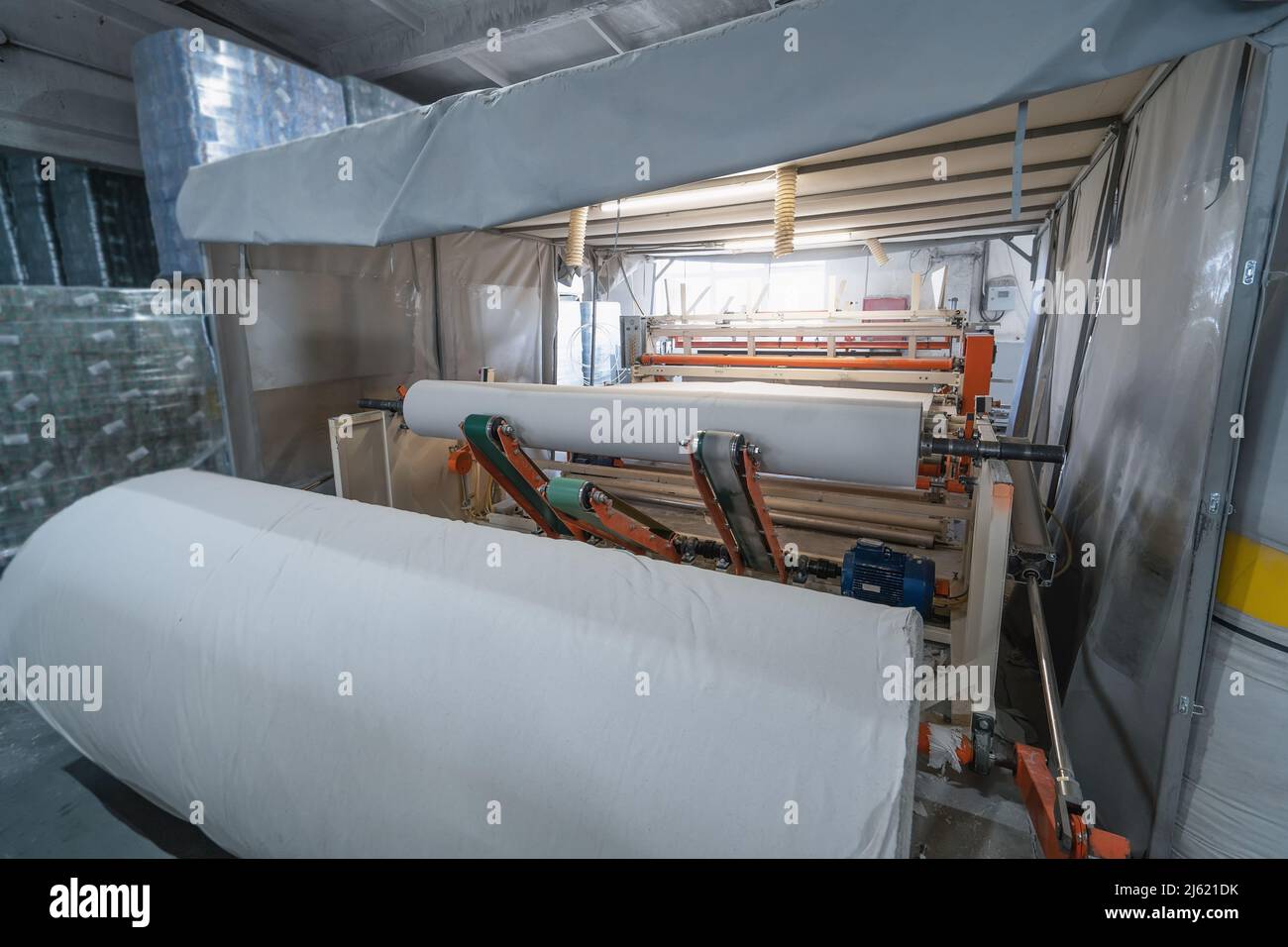 Toilet paper production. Machine with a large roll of recycled paper