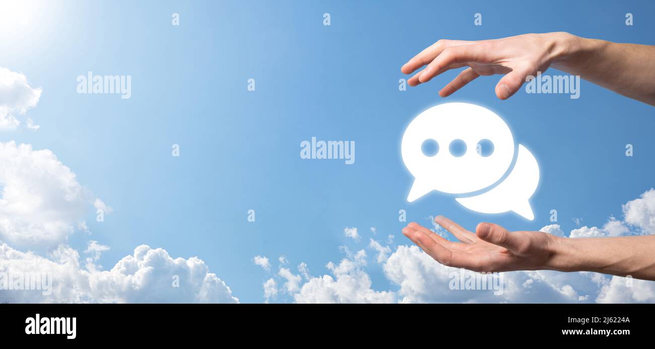 Businessman holding a message icon, bubble talk notification sign in ...