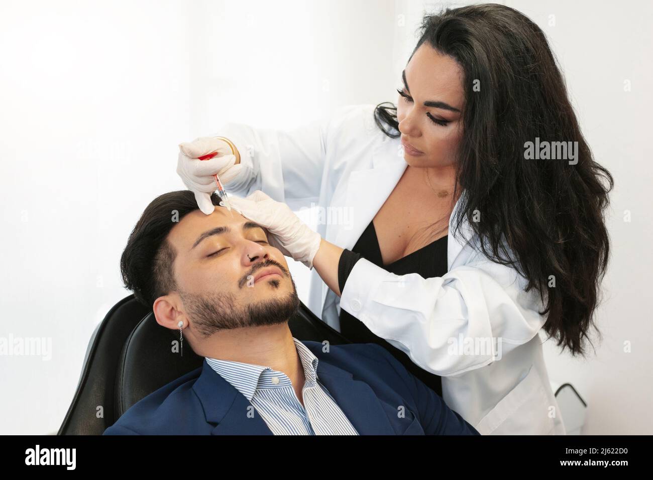 Dermatologist doing botox treatment on patient at aesthetic clinic Stock Photo