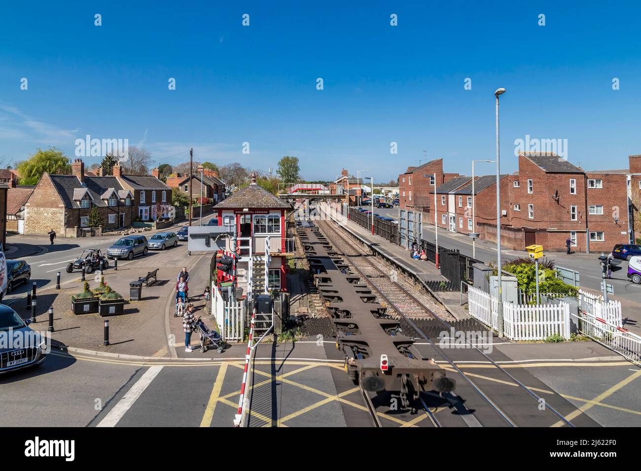 Container train going through Oakham station on a  afternoon, looking down from the foot bridge over the tracks, Rutland, Leicester, England, UK. Stock Photo