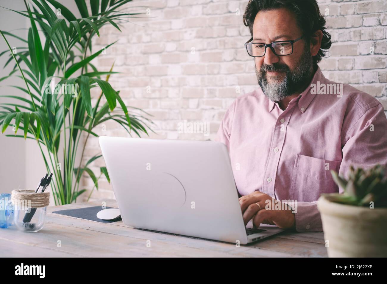 Freelancer using laptop at home Stock Photo