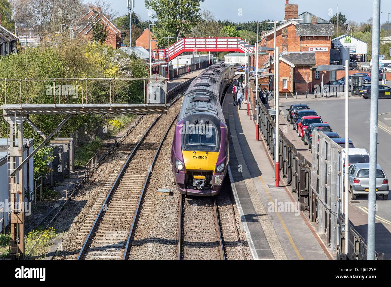 Diesel-electric passenger train leaving Oakham station, looking down from the foot bridge over then tracks, Rutland, Leicester, England, UK. Stock Photo