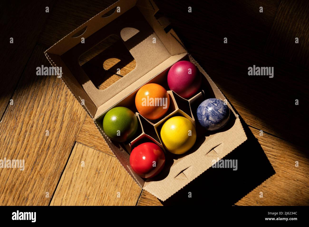Egg carton with colorful Easter eggs Stock Photo
