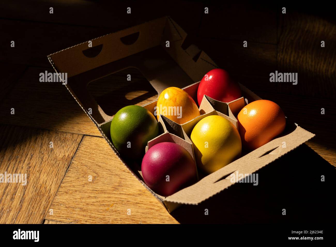 Egg carton with colorful Easter eggs Stock Photo