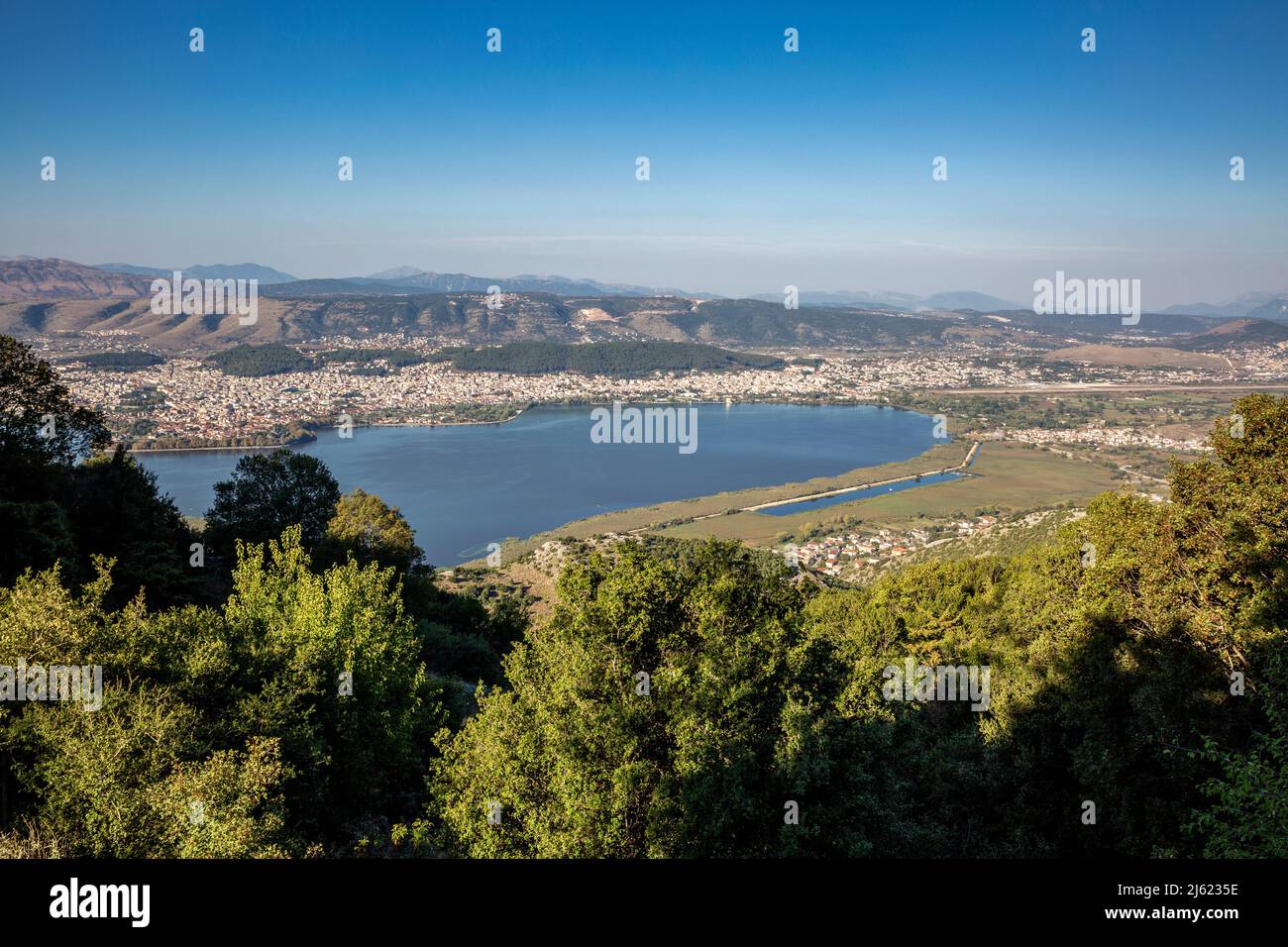Greece, Epirus, Ioannina, View of Lake Pamvotida and surrounding city in summer Stock Photo