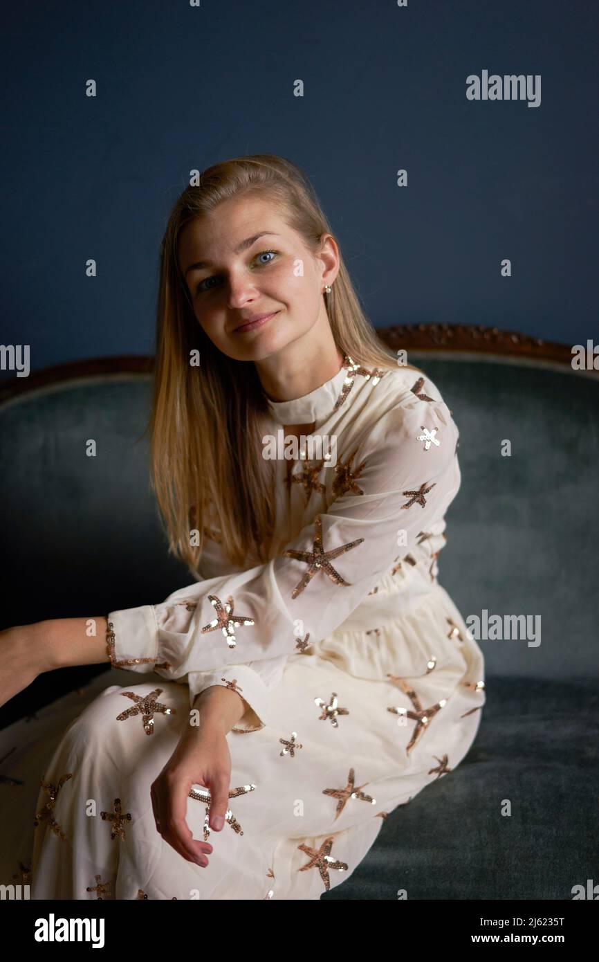Woman sitting sofa hi-res stock photography and images - Alamy
