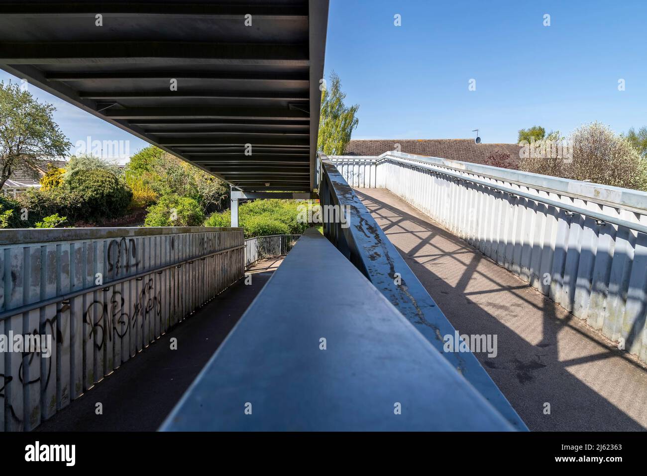 Metal public walkway over the railway lines in Oakham, Rutland ...
