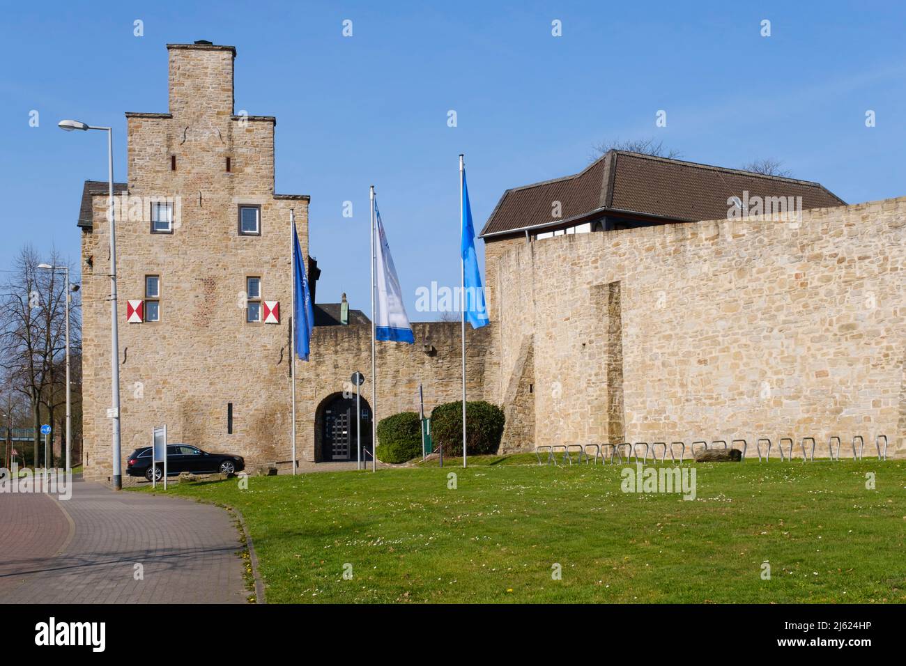 Germany, North Rhine-Westphalia, Mulheim an der Ruhr, Street lights and flagpoles in front of Broich Castle Stock Photo