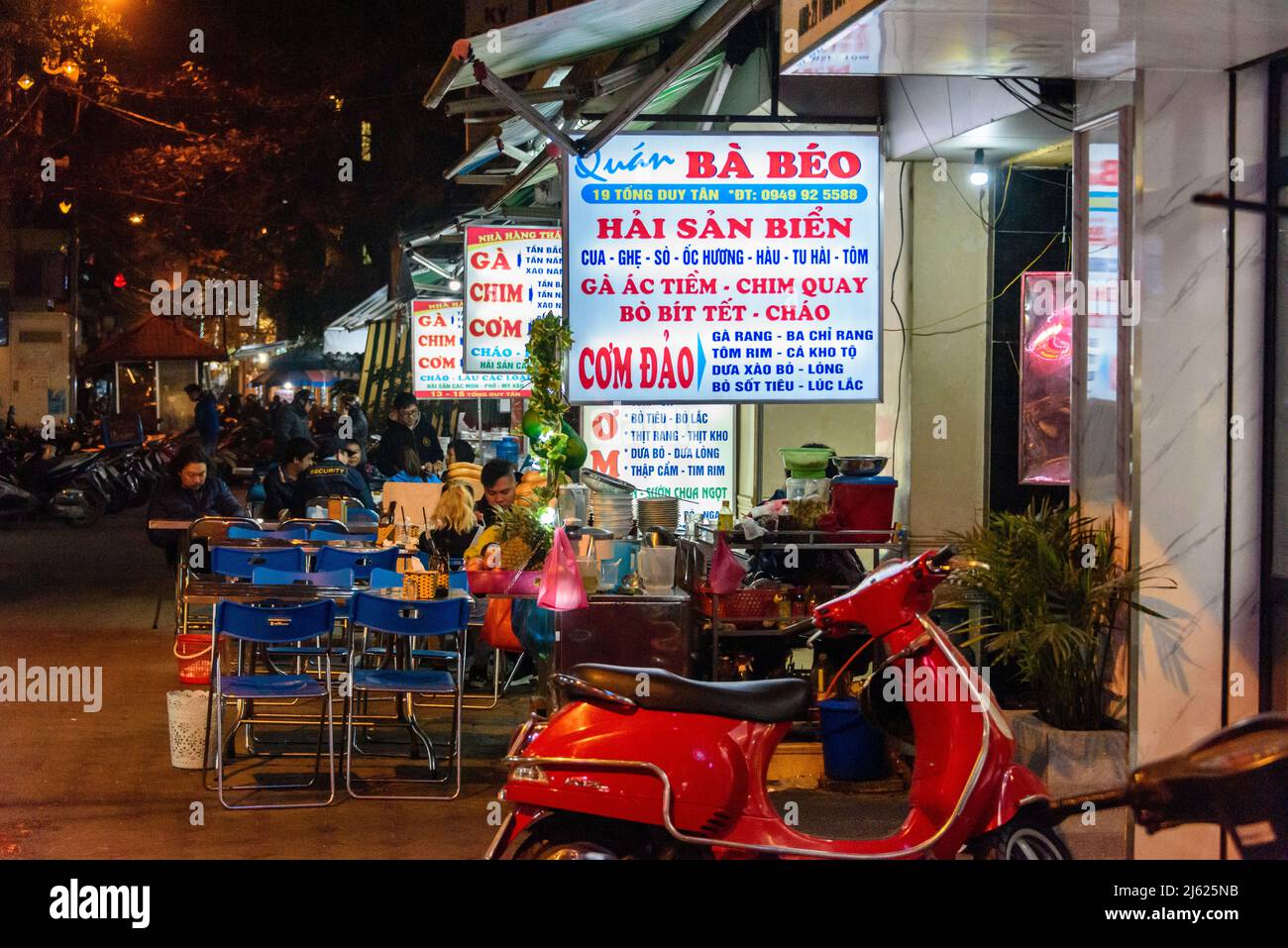 Outside a row of restaurants in Hanoi, Vietnam at night. Stock Photo