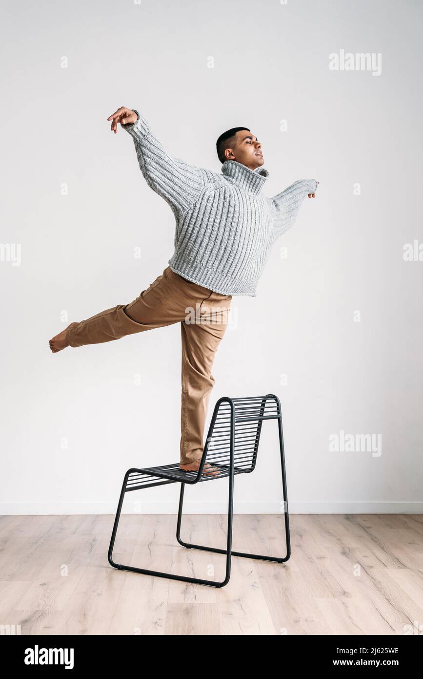 Man balancing on chair hi-res stock photography and images - Alamy