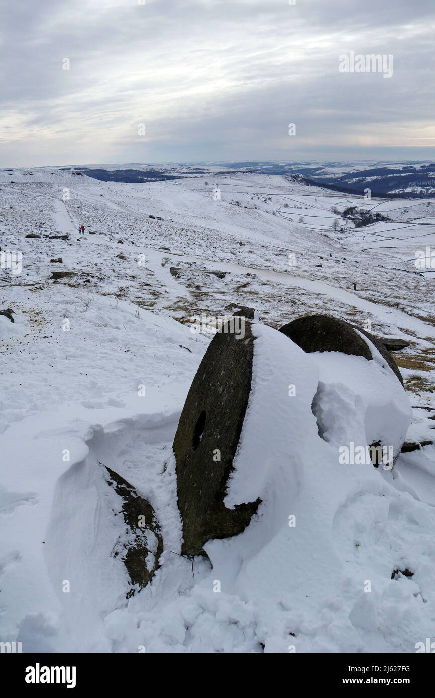 Snow covered millstones Peak District Derbyshire Stock Photo
