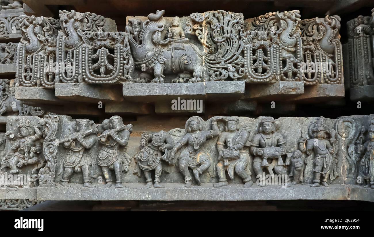 Sculpture of man sitting on a Elephant and And Dancers on Downside, Hoysalesvara Temple, Halebeed, Karnataka, India Stock Photo