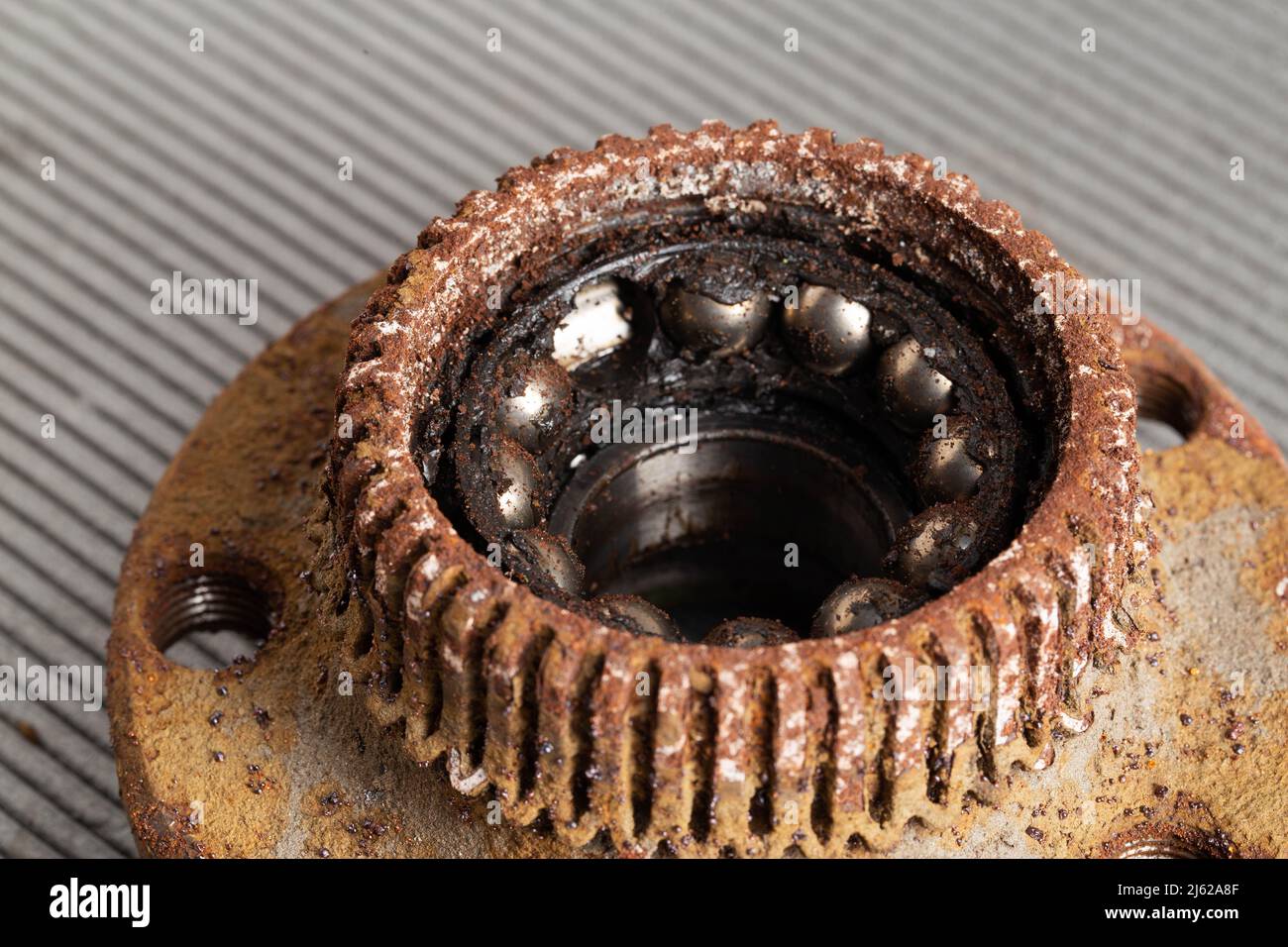 Old rusty wheel hub with a broken bearing. Bearing jamming. Automotive