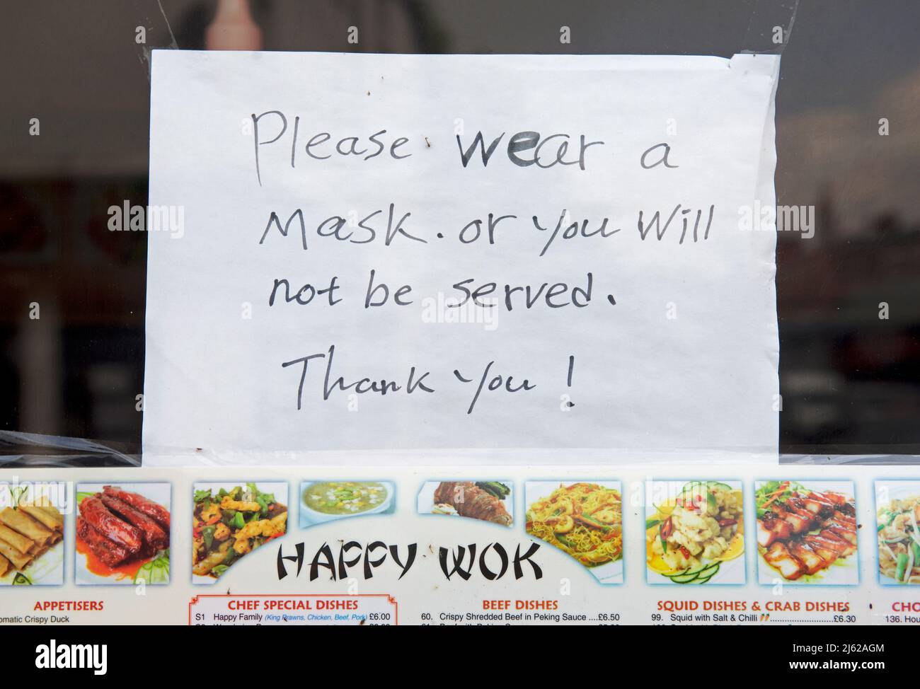 Sign on door of Chinese take-away, telling customers to wear a mask, England UK Stock Photo