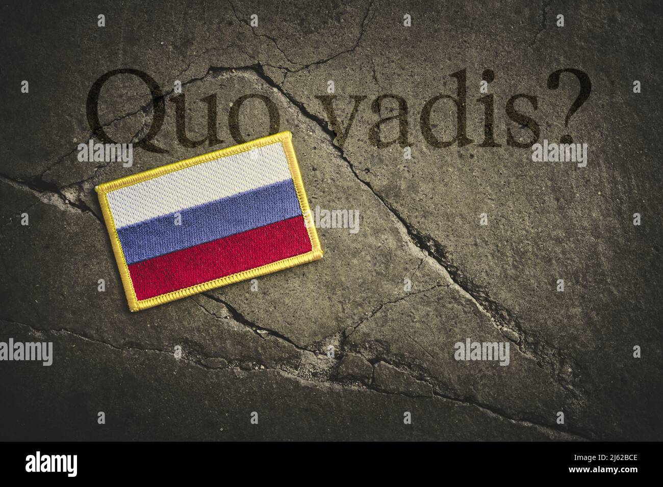 Quo Vadis Is Written Above The Flag Of Russia On Broken Ground Stock Photo