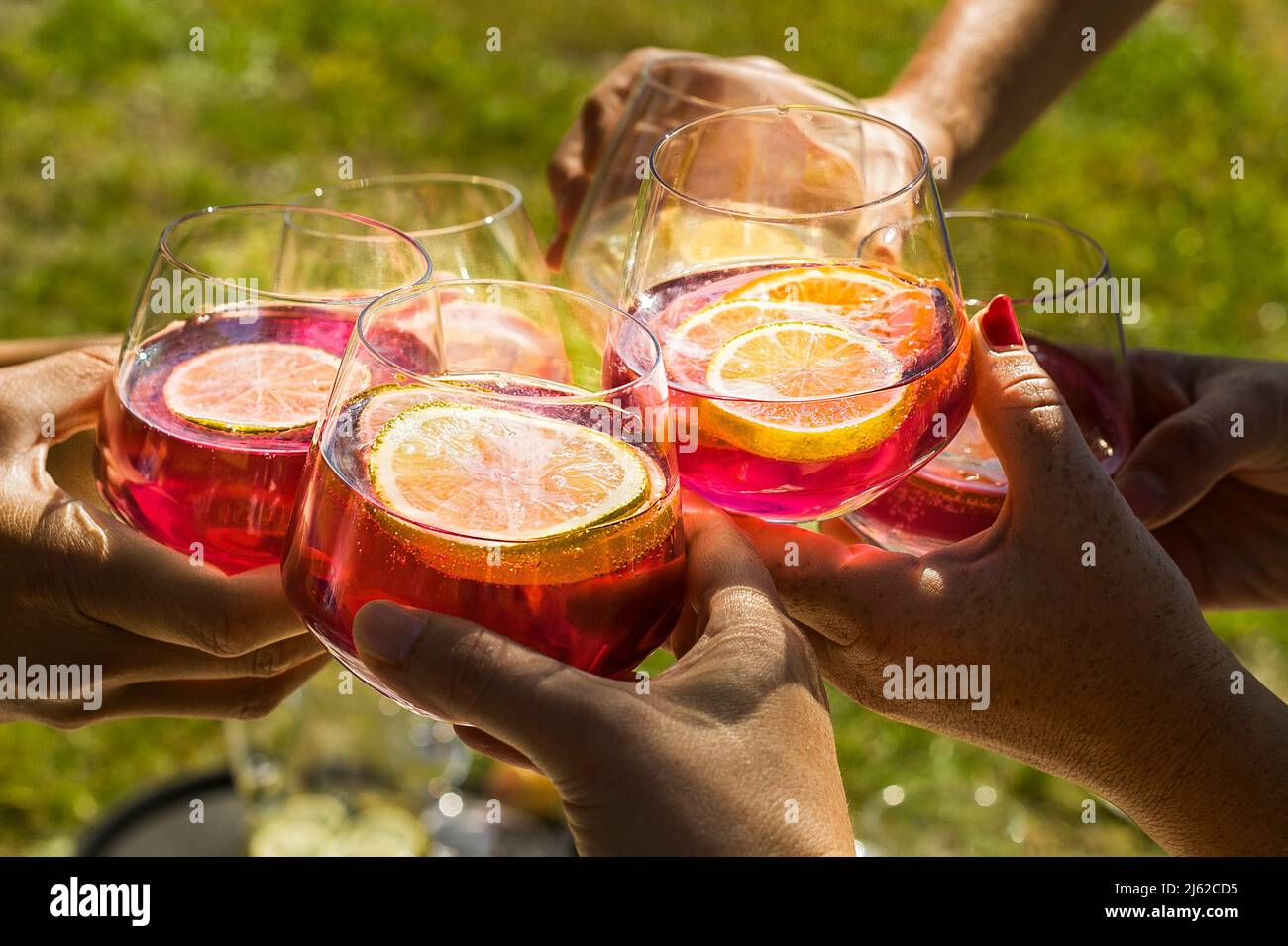 toast of six glasses with Aperol and lemon slices Stock Photo