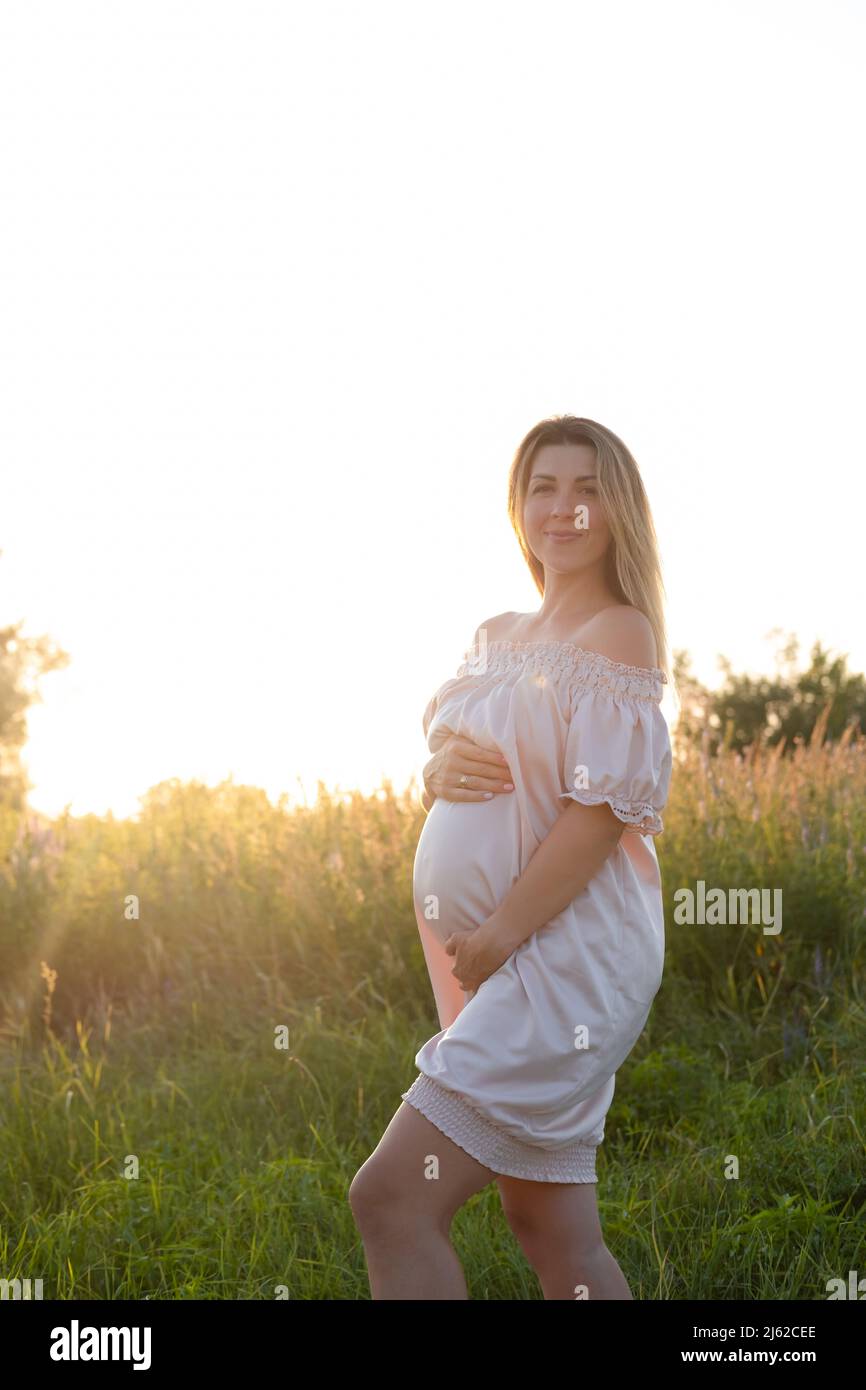 tender pregnancy portrait on sunset. expecting mother to be outside in ...