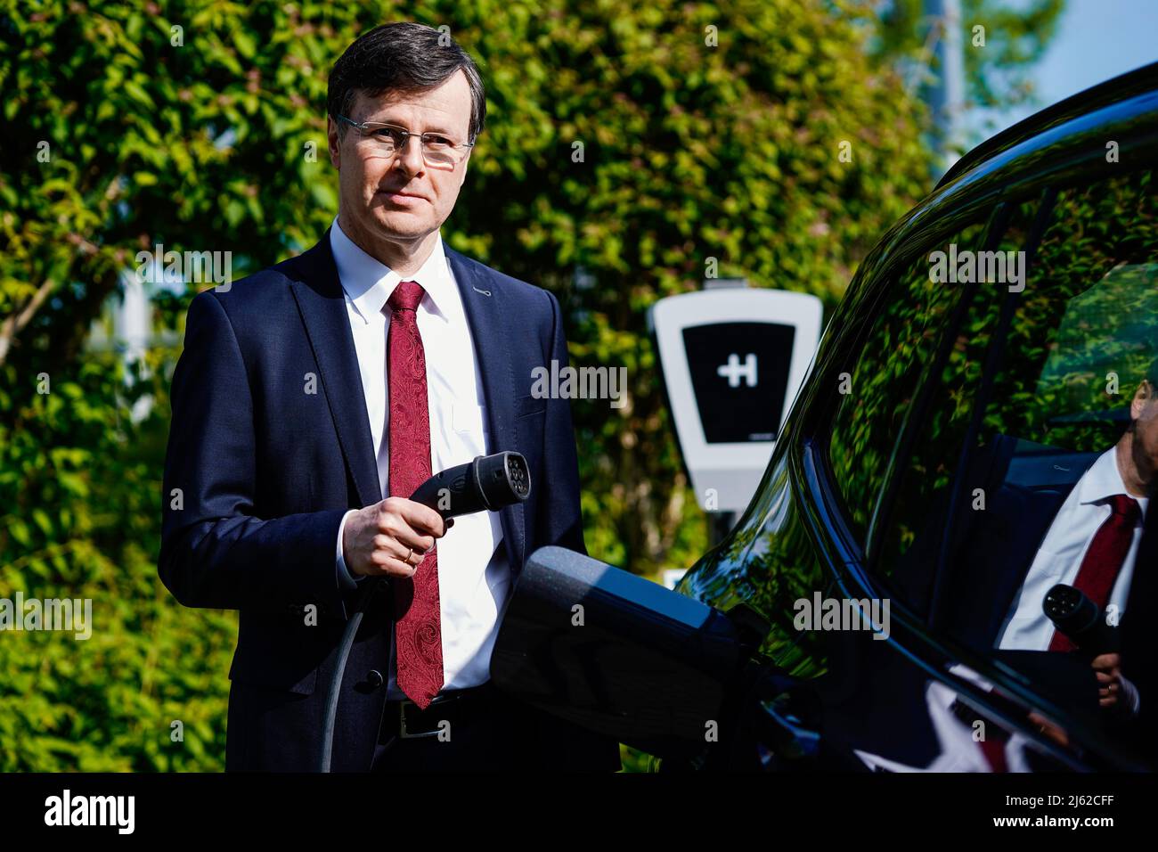 Wiesloch, Germany. 27th Apr, 2022. Ludwin Monz, CEO of Heidelberger  Druckmaschinen AG, stands at the company's headquarters with the charging  plug of a "wallbox" type charger attached to an electric drive vehicle.