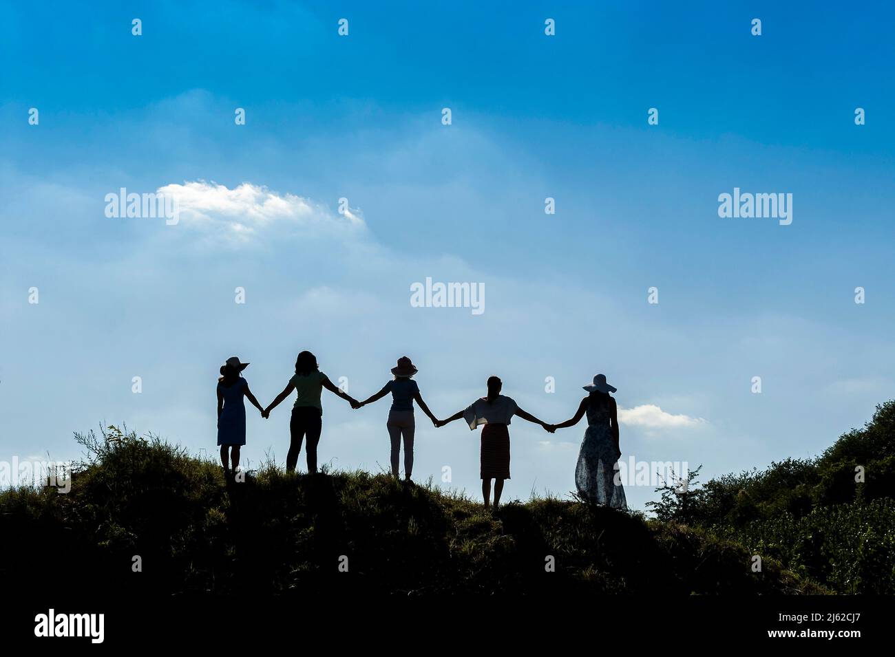 skyline silhouette of five women on the hill Stock Photo - Alamy