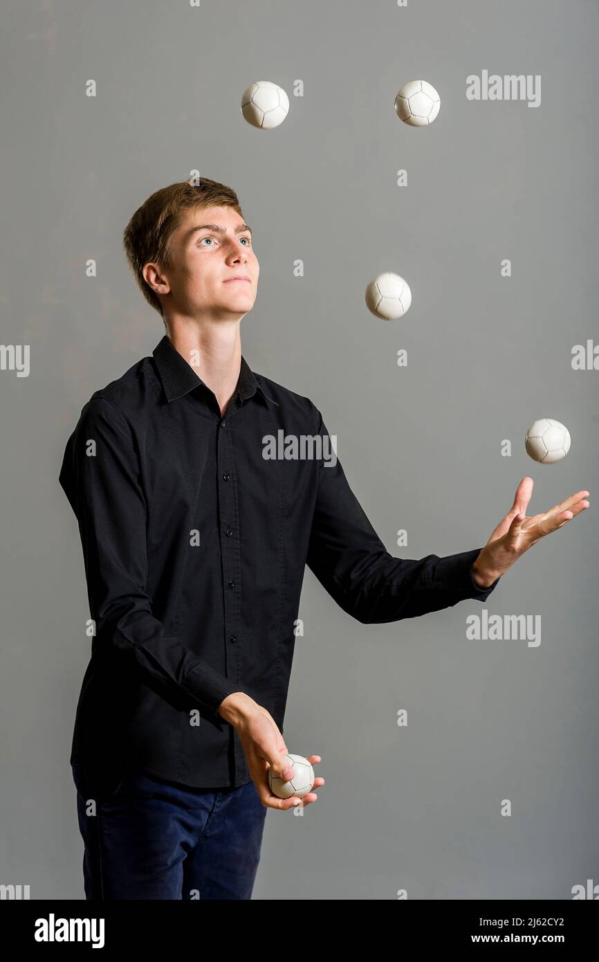 juggler boy juggles with three balls Stock Photo