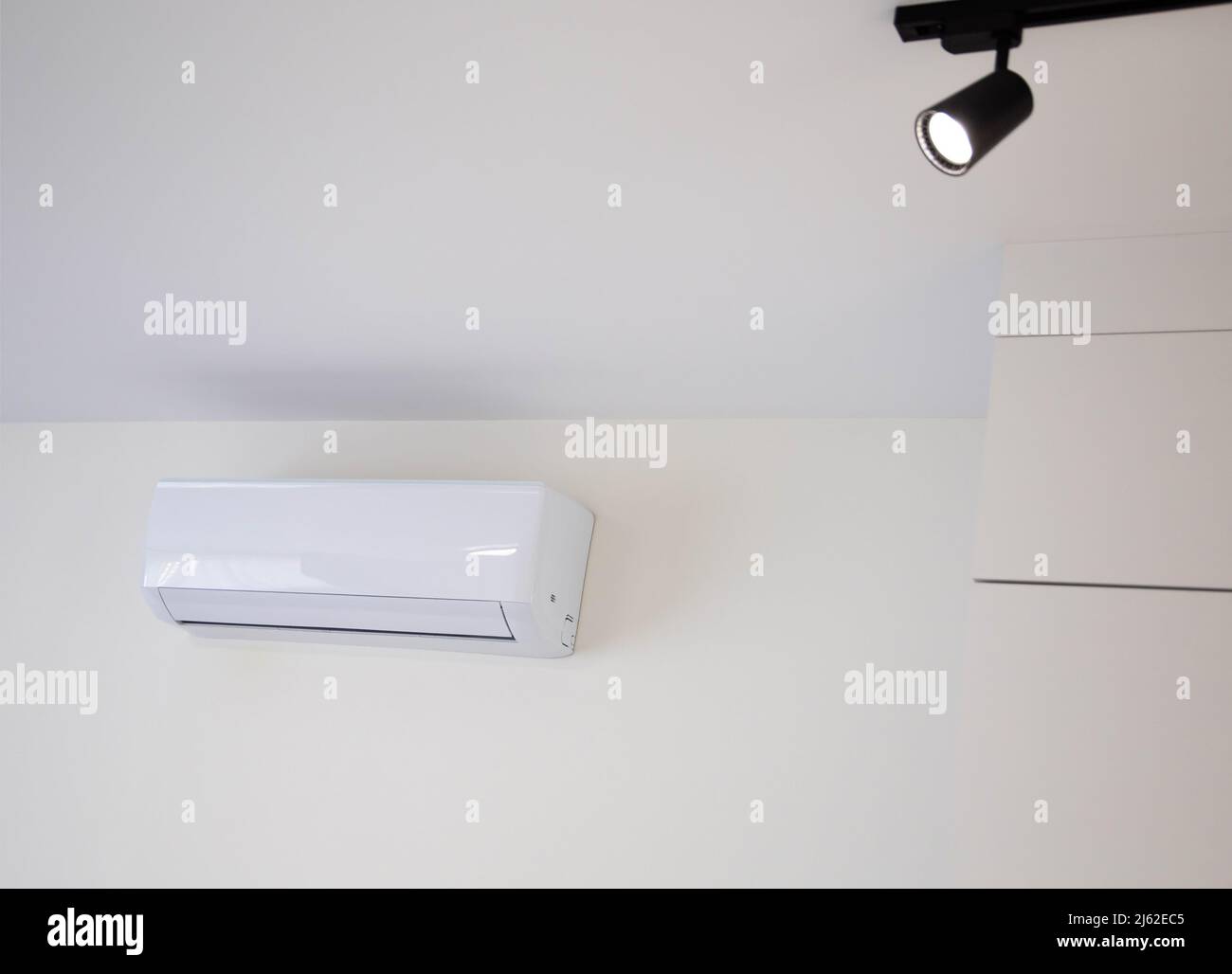 Modern wall-mounted air conditioner in the apartment with heating and cooling capacity of the room. Comfortable temperature Stock Photo