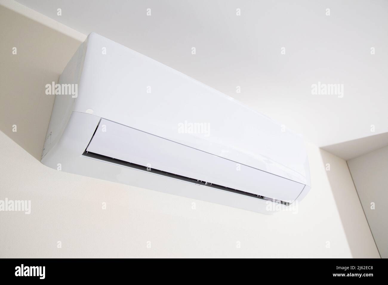 Wall mounted air conditioner in a modern apartment. The concept of maintaining a comfortable