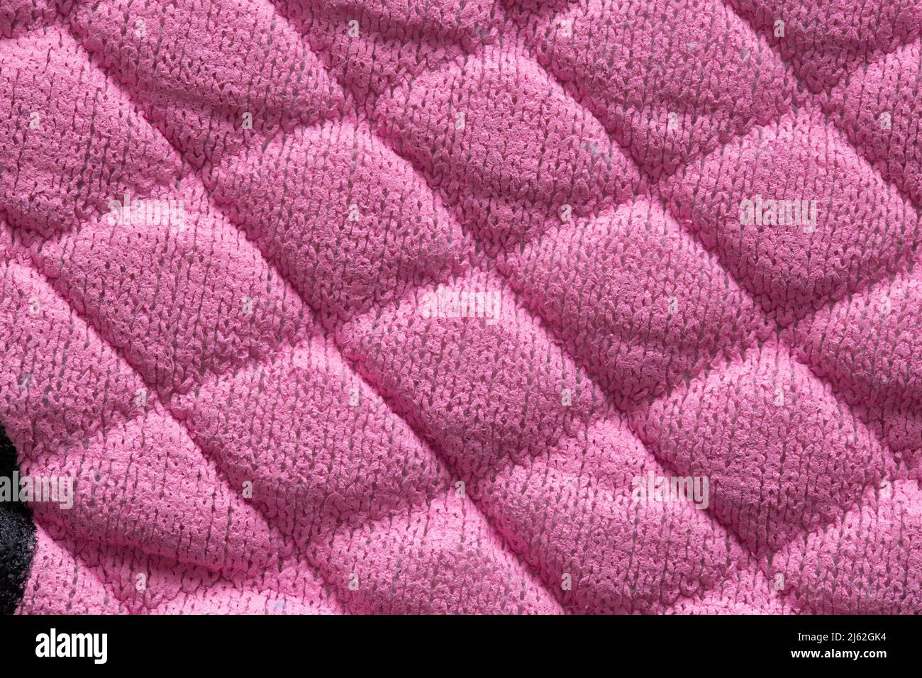 Pink new fabric in diamond pattern, background, macro. Stylish Stock Photo