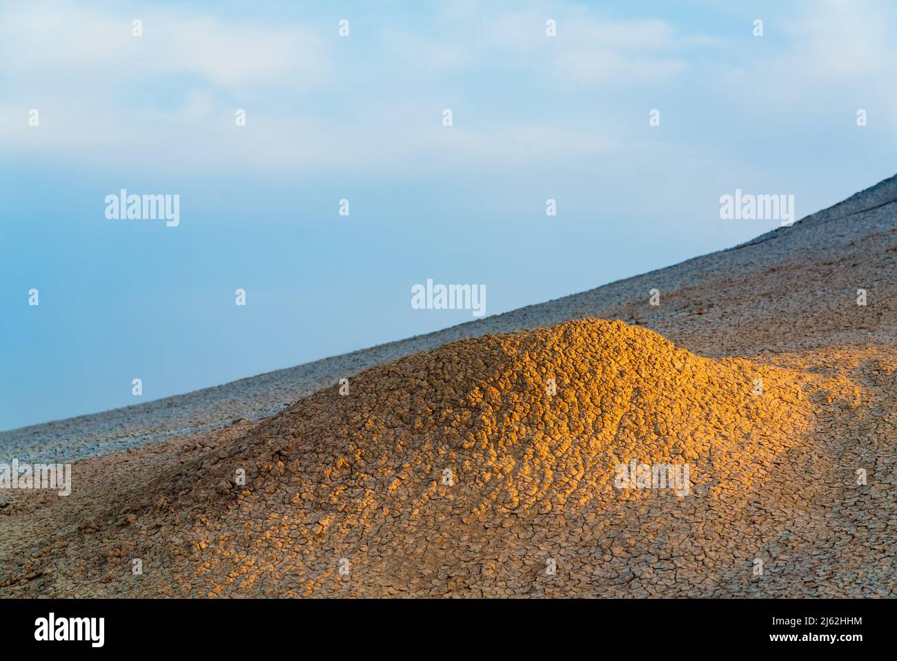 Mud volcano slope at sunset time Stock Photo