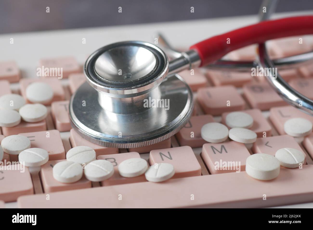 Close up of pills and stethoscope on keyboard  Stock Photo