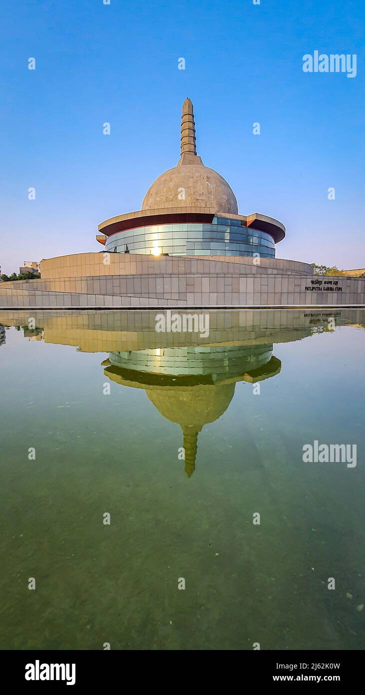 buddha stupa with water reflection and bright blue sky at morning image is taken at buddha park patna bihar india on Apr 15 2022. Stock Photo