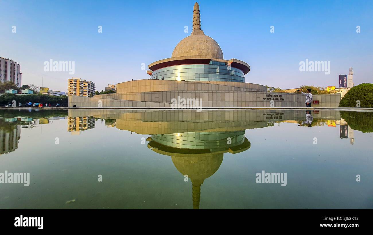 buddha stupa with water reflection and bright blue sky at morning image is taken at buddha park patna bihar india on Apr 15 2022. Stock Photo