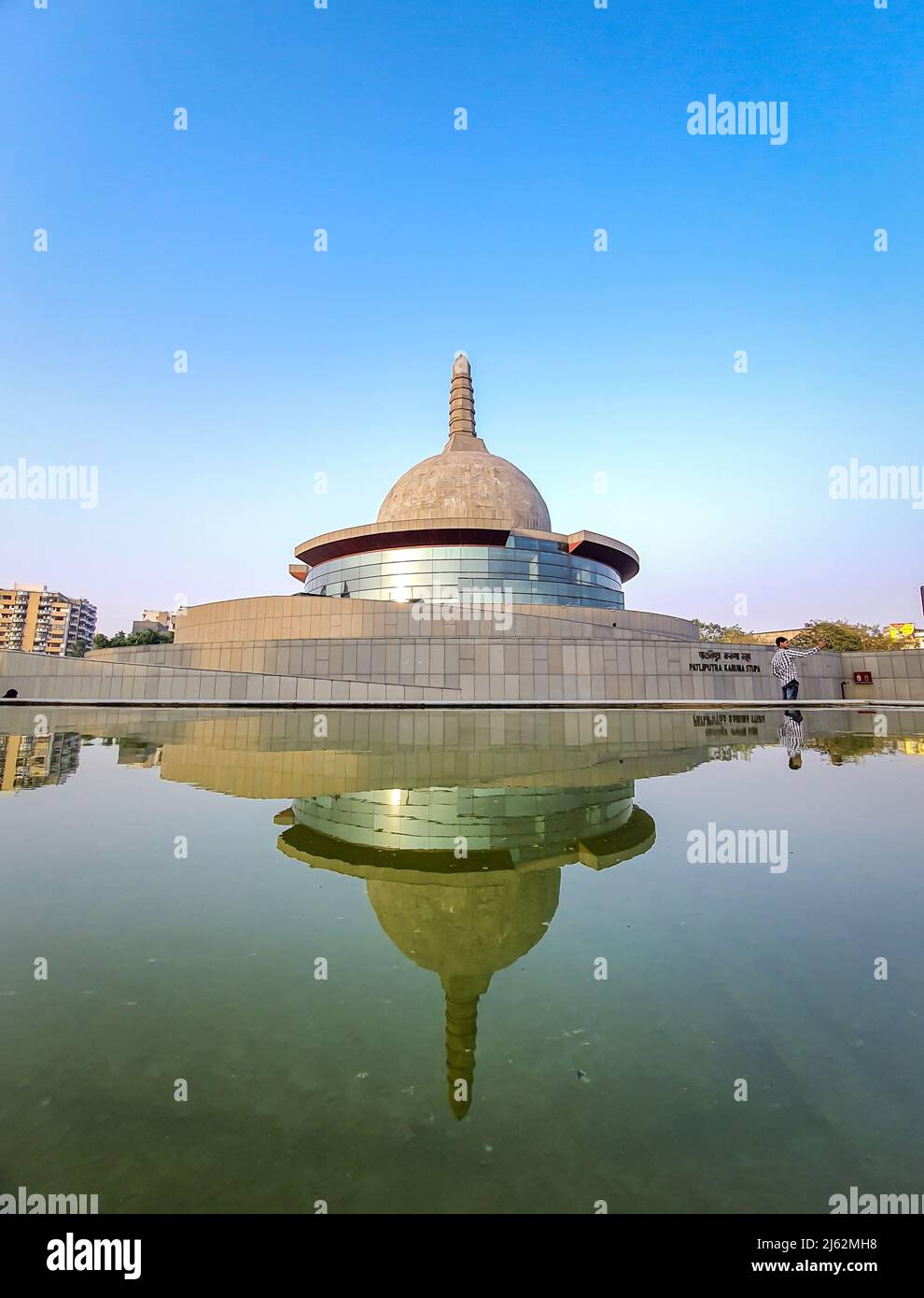 buddha stupa with water reflection and bright blue sky at morning image is taken at buddha park patna bihar india on Apr 15 2022. Stock Photo