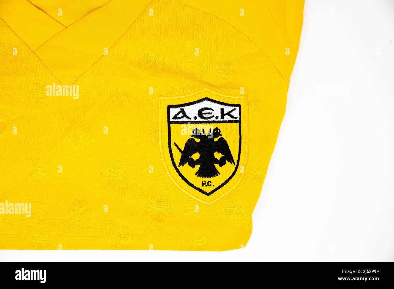 AEK Athens FC badge on the front of a folded yellow puma football shirt  Stock Photo - Alamy