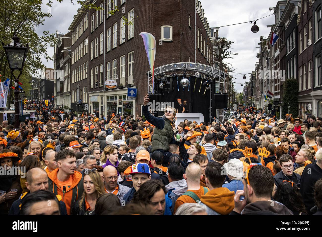 AMSTERDAM, Netherlands, 2022-04-27 - Revelers in the Jordaan in the  capital. After two years in which King's Day had to be celebrated on a  small scale due to the corona pandemic, the